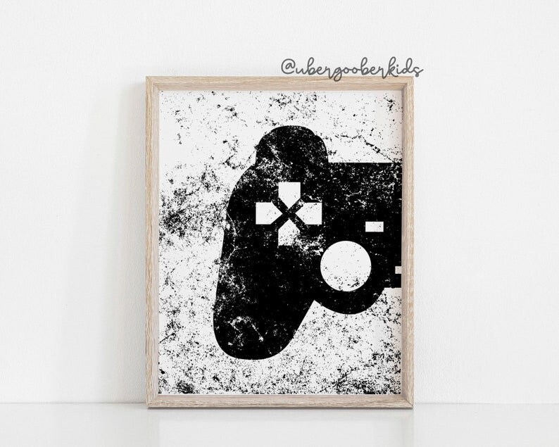 May include: Black and white illustration of a video game controller with a distressed background. The controller is in the shape of a traditional gamepad with a directional pad, buttons, and a joystick. The background is a white surface with black speckles.