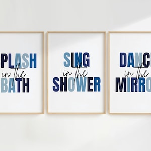 May include: Three framed prints with blue and white text. The first print says "SPLASH in the BATH", the second print says "SING in the SHOWER", and the third print says "DANCE in the MIRROR".