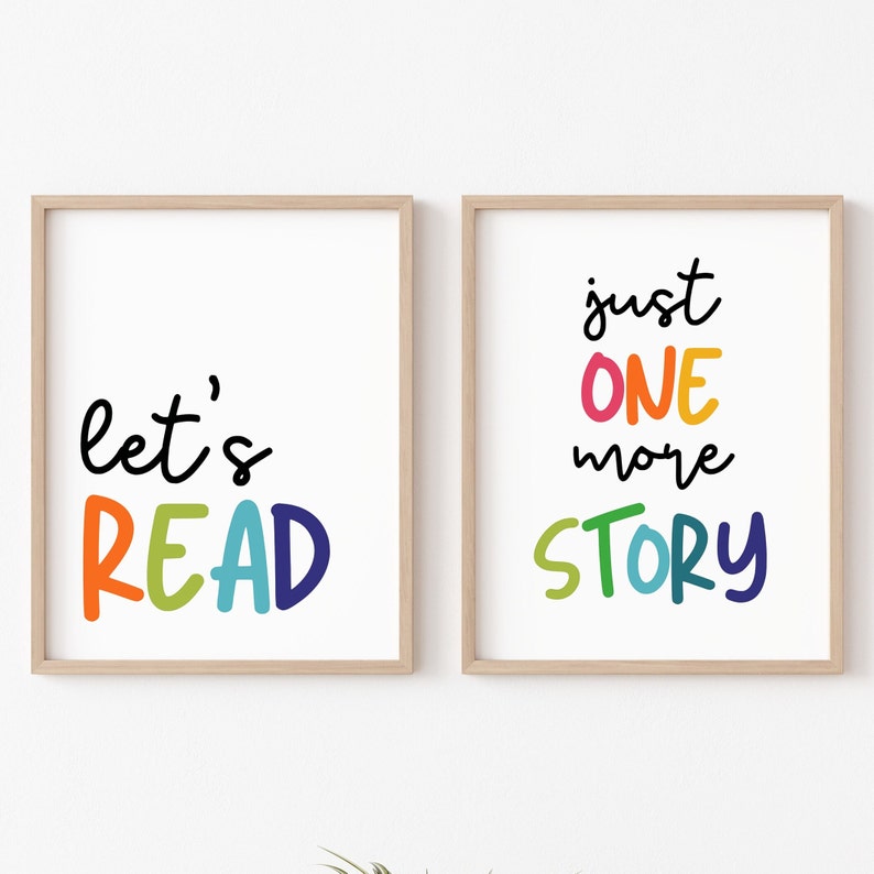 May include: Two framed prints with colorful text. The left print says "let's READ" in rainbow colors. The right print says "just ONE more STORY" in rainbow colors.