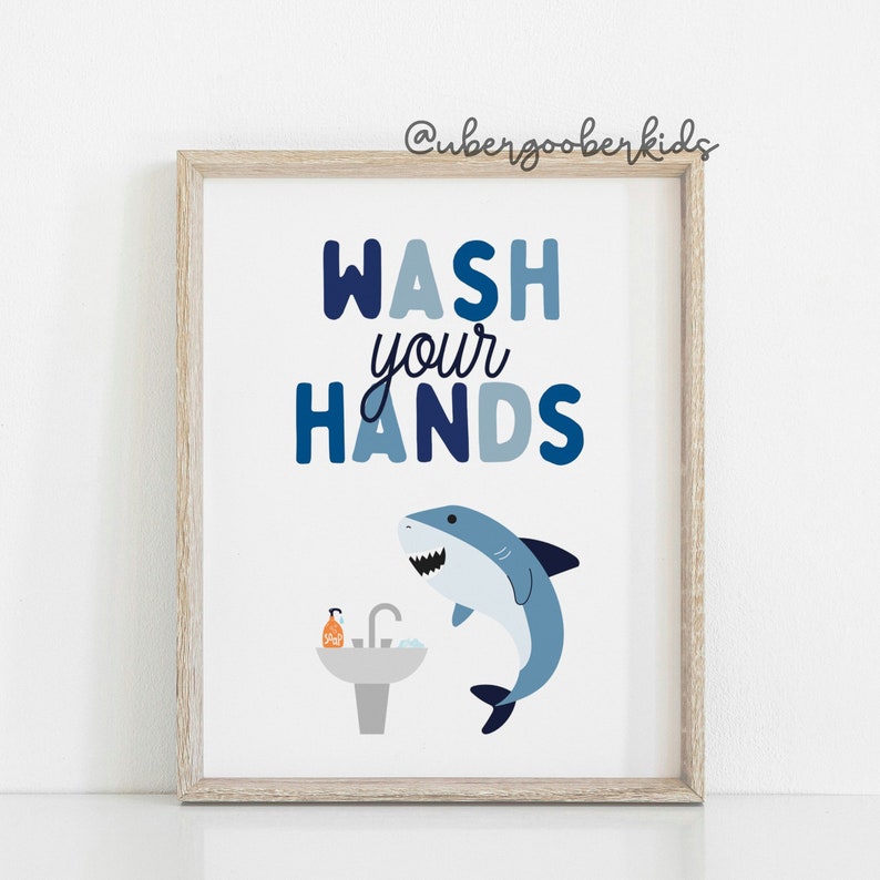 May include: A blue and white printable sign with the text "WASH your HANDS" and a cartoon shark jumping out of a sink.