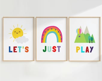May include: Three colorful framed prints with a sun, rainbow, and mountains with a hot air balloon. The text on the prints reads "Let's", "Just", and "Play".