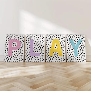 May include: Four black and white polka dot prints with the word "PLAY" in large, colourful letters. The letters are pink, purple, yellow, and blue.