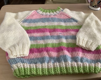 Two new girls hand knitted multi coloured woollen jumpers up to 22 inch chest