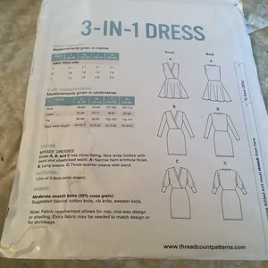 May include: A sewing pattern for a 3-in-1 dress with three different styles: a fit and flare dress, a long-sleeved dress, and a three-quarter sleeve dress. The pattern includes measurements in inches and centimeters.