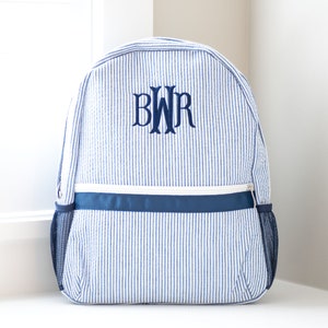 May include: A blue and white striped backpack with a navy blue zipper and a navy blue monogram "BWR" embroidered on the front.