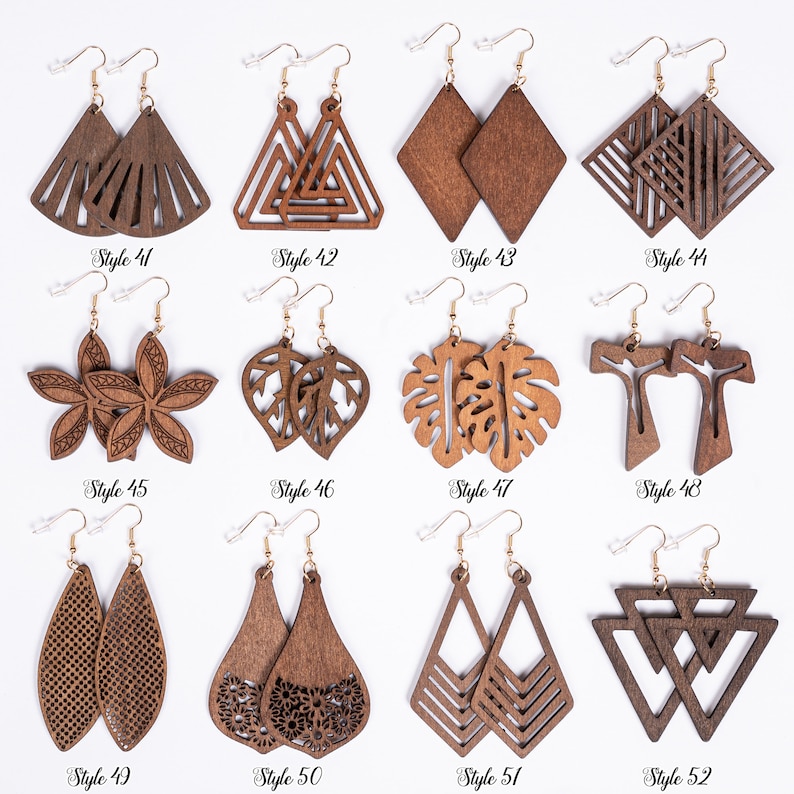 May include: Twelve pairs of wooden earrings with various geometric and nature-inspired designs. The earrings are all brown and have gold hooks.