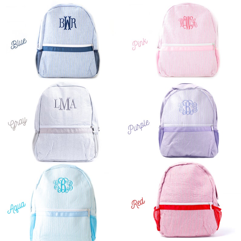 May include: Six different colored monogrammed backpacks with white stripes. The colors are blue, pink, gray, purple, aqua, and red.
