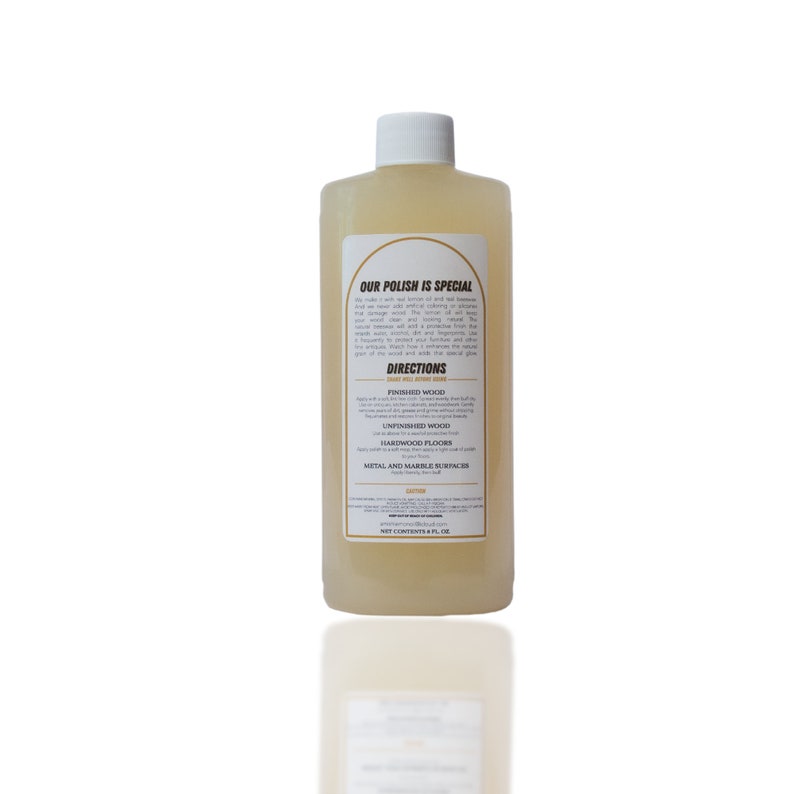 May include: A clear bottle of wood polish with a white cap. The label reads "OUR POLISH IS SPECIAL" and includes directions for use on finished and unfinished wood, hardwood floors, and metal and marble surfaces. The bottle contains 8 fl oz.