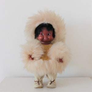Vintage vinyl doll dressed in traditional suede and faux fur outfit