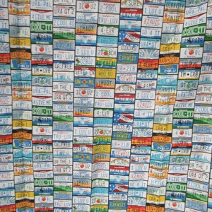 License plates allover 100% cotton fabric that has all plates in the USA and has 18 inches by 43 inches wide neat fabric.