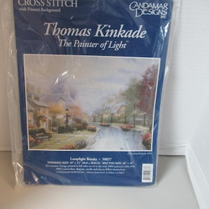 May include: A cross-stitch kit featuring a Thomas Kinkade painting titled "Lamplight Brooke." The kit includes a design printed on Aida cloth, measuring 16 x 12 inches (40.8 x 30.6 cm) when finished. The matted size is 20 x 16 inches.