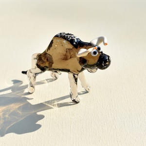 Grey transparent Glass Bull. Detailed figurine with a lot of personality. Excellent addition to your glass menagerie collection.