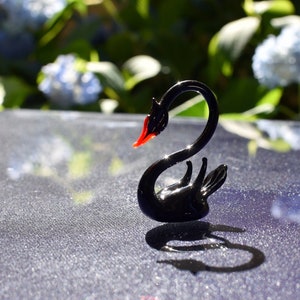 Gracious Glass black swan. Whimsical figurine with a lot of character and personality. Excellent addition to you glass menagerie collection