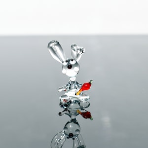 Cute Glass Bunny with carrot. Whimsical figurine with a lot of character. Excellent addition to your collection and, a unique gift.