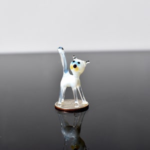 Cute white with blue eyes glass Kitty-cat. Whimsical figurine with character and personality. Excellent addition to your collection.