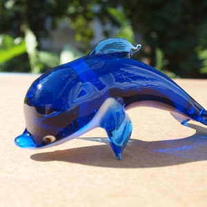 Cute Glass blue dolphin. Detailed figurine with a lot of character and personality.  Excellent addition to you glass menagerie collection