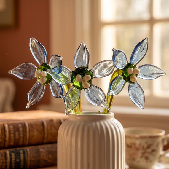 A flame-worked borosilicate glass forget-me-not bloom — a botanically detailed forever flower sculpted by hand that will never wilt.