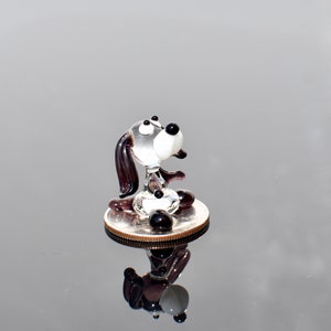 Cute Tiny clear with deep purple glass dog. Whimsical figurine with a lot of character. Excellent addition to your collection.