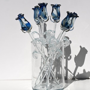 Gorgeous clear- blue glass long-stem rose flower. Excellent addition to your glass collection. Each flower is priced individually.