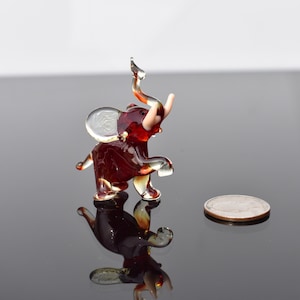 Cute  Red Glass Elephant with tasks. Whimsical figurine, lot of character and personality. Excellent addition to your glass collection.