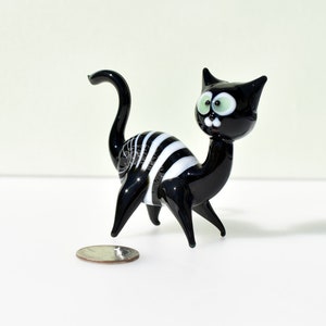 Whimsical Glass black Cat. Detailed figurine with a lot of character and personality.  Excellent addition to you glass menagerie collection