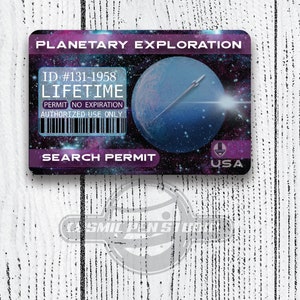 May include: A purple and black card with the text "PLANETARY EXPLORATION" and "SEARCH PERMIT" in white. The card has a blue planet image with a white arrow and the text "ID #131-1958 LIFETIME PERMIT NO EXPIRATION AUTHORIZED USE ONLY USA".