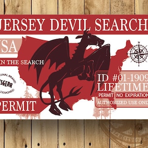 May include: A red and white card with the text "Jersey Devil Search" and "USA" on it. The card features a black silhouette of a Jersey Devil, a mythical creature, standing on a map of the United States. The card also includes a compass and the text "ID #01-1909 LIFETIME PERMIT NO EXPIRATION AUTHORIZED USE ONLY".