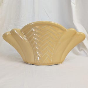 May include: A set of three ceramic nesting bowls in graduating sizes. The bowls feature a speckled, off-white glaze with a slightly textured surface. Each bowl has a rounded shape and a simple, minimalist design.