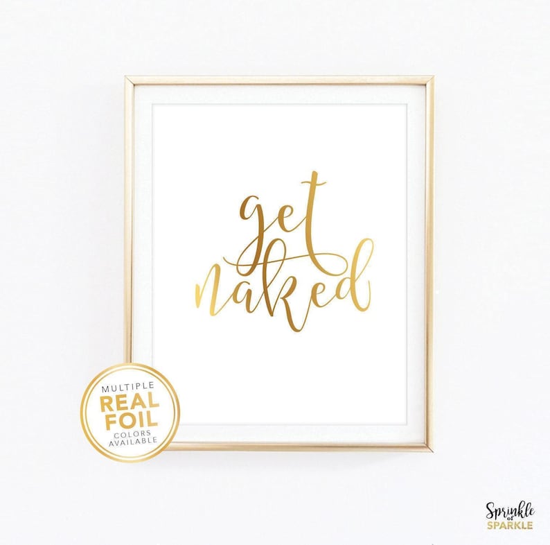A gold foil wall art print with the words get naked in gold foil in a beautiful script font. A great piece of gold decor for a bedroom, bathroom, washroom and more.