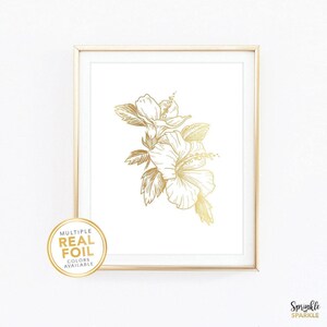 Add a touch of elegance to your space with this floral wall art featuring a delicate botanical design in real gold foil of a Hibiscus flower. Printed on a clean white background, this minimalist artwork brings warmth and sophistication to bedrooms, nurseries, living rooms, or offices. Available in multiple sizes including 4x6, 5x7, 8x10, 8.5x11, and more. Foil colors such as gold, rose gold, silver, and more. If white isn't your style we also have paper in black, pink, blush, navy and more.
