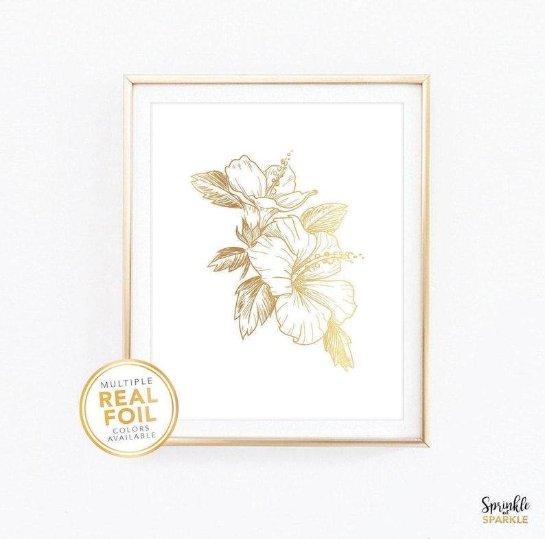 Add a touch of elegance to your space with this floral wall art featuring a delicate botanical design in real gold foil of a Hibiscus flower. Printed on a clean white background, this minimalist artwork brings warmth and sophistication to bedrooms, nurseries, living rooms, or offices. Available in multiple sizes including 4x6, 5x7, 8x10, 8.5x11, and more. Foil colors such as gold, rose gold, silver, and more. If white isn't your style we also have paper in black, pink, blush, navy and more.