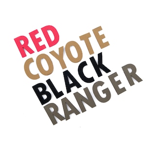 May include: Red, brown, black and grey felt letters spelling out "Red Coyote Black Ranger".