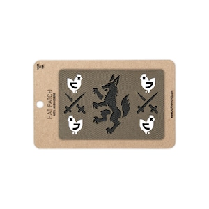 May include: A rectangular olive green hat patch with hook velcro backing, mounted on a cardboard display card. The patch features a black central wolf silhouette flanked by two white chicken icons and two crossed swords on each side. Text reads HAT PATCH WITH HOOK VELCRO, MADE IN USA, and WWW.ALPINHOUND.COM.