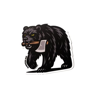 May include: Black bear sticker with a yellow axe in its mouth. The sticker has the text "Plumwood 2023" on the bottom left corner.