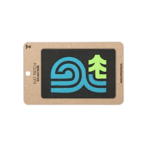 May include: A rectangular black hat patch with hook velcro backing, featuring a stylized graphic in bright blue and lime green. The text on the cardboard backing reads HAT PATCH WITH HOOK VELCRO, MADE IN USA, and ALPHAHOUND.COM.