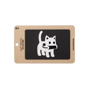 May include: A rectangular black hat patch with hook velcro backing, featuring a white embroidered graphic of a cat holding a lit dynamite stick. The patch is mounted on a tan cardboard display card labeled HAT PATCH WITH HOOK VELCRO.