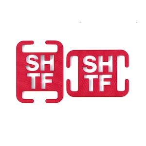 May include: Two red plastic shift knobs with the words "SH TF" printed in white.