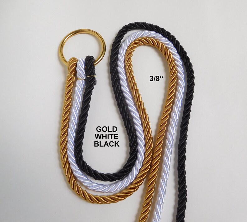 May include: Three twisted ropes in gold, white, and black, each measuring 3/8 inches in diameter, are looped through a single circular gold metal ring. The text GOLD WHITE BLACK is printed near the ropes, indicating the available color options.