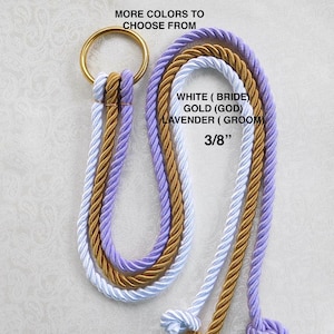 May include: Three strands of braided rope in white, gold, and lavender colors. The rope is 3/8 inch thick and has a gold metal ring at the top. The text "MORE COLORS TO CHOOSE FROM" is at the top of the image. The text "WHITE (BRIDE) GOLD (GOD) LAVENDER (GROOM) 3/8" is at the bottom of the image.