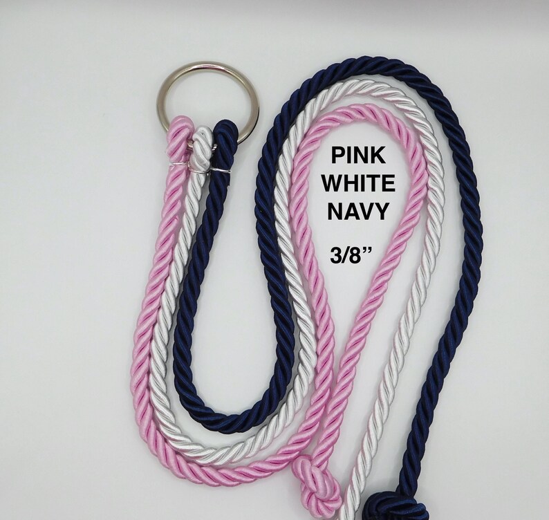 May include: A set of three twisted ropes in pink, white, and navy blue, each attached to a single silver metal ring. The ropes feature a 3/8 inch diameter and include the printed text PINK WHITE NAVY 3/8" on the white rope section.