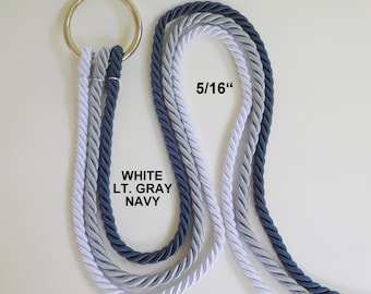 May include: A gold-toned metal ring holds three twisted ropes in white, light gray, and navy blue. The ropes are 5/16 inches in diameter. The text WHITE LT. GRAY NAVY is printed near the ropes, and 5/16" is printed near the top.