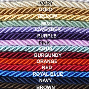 May include: A collection of 3/8 inch twisted rope cords arranged horizontally in various colors including white, ivory, gold, yellow, mint, lavender, purple, pink, aqua, burgundy, orange, red, royal blue, navy, brown, silver, and black.