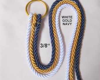 May include: Three twisted ropes in white, gold, and navy blue colors attached to a circular gold-toned metal ring. The ropes measure 3/8 inches in diameter. The text WHITE GOLD NAVY is printed on the image, along with the measurement 3/8 inch.
