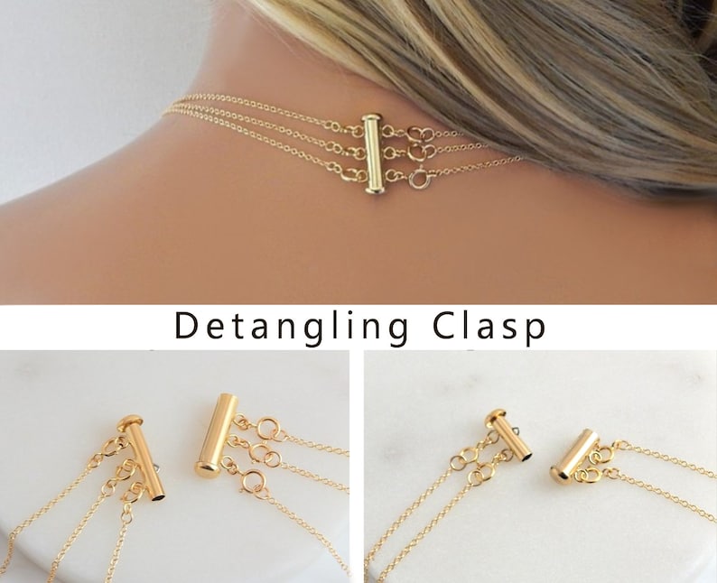 May include: Gold-toned necklace with a multi-strand design, featuring a detangling clasp. The clasp is a vertical bar with multiple loops for attaching the necklace strands. The text "Detangling Clasp" is visible below the image.