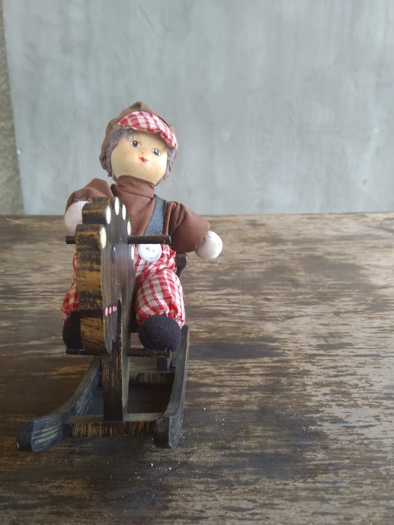 porcelain doll on rocking horse