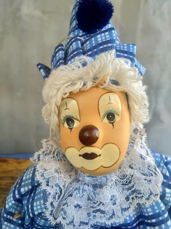 porcelain clown doll on swing