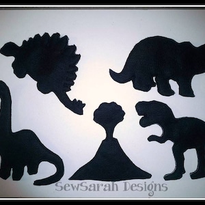 May include: Black felt dinosaur silhouettes, including a stegosaurus, triceratops, brachiosaurus, and a T-Rex, with a volcano in the center. The text "SewSarah Designs" is at the bottom of the image.