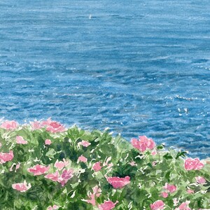 Close-up detail of Spruce Point highlighting pink roses against the sparkling blue waters of Boothbay Harbor.