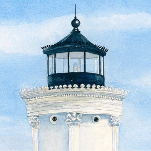 Close-up detail of Bug Light showcasing the lighthouse lantern room against a soft blue coastal sky.