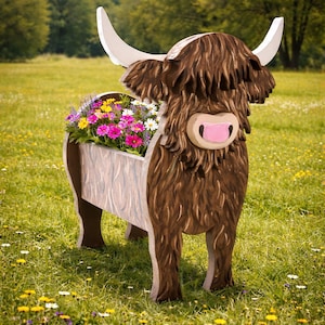 May include: A wooden Highland cow planter filled with colorful flowers. The cow has brown fur, white horns, and a pink nose. The planter is set in a grassy field with a blue sky background.